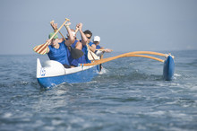 Multiethnic Outrigger Canoeing Team In Race