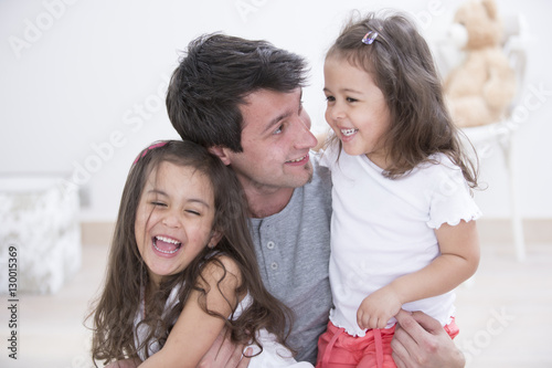 Fotografie, Obraz Happy father with daughters spending quality time together at home