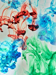 Wall Mural - Multi-coloured substances dissolving in water