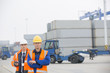 © MDBPIXS - Portrait of confident workers standing in shipping yard