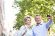 © MDBPIXS - Happy middle-aged couple taking selfie outdoors