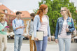 © MDBPIXS - Young college friends walking on street