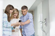 © MDBPIXS - Middle-aged man with daughters using smart phone at home
