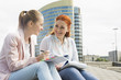 © MDBPIXS - Smiling young university students studying against building