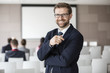 © MDBPIXS - Portrait of happy businessman standing in seminar hall