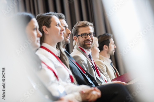 Photographie Portrait of confident businessman sitting in seminar hall