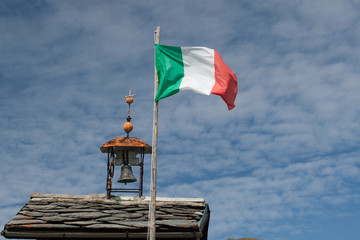 Italian flag waving on blue sky