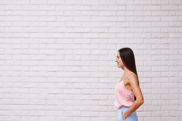 Wall Mural - Side view of lean bare shoulders woman in stylish suit looking f