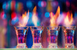 © Sergey Novikov - Four hot shot glasses on a bar counter