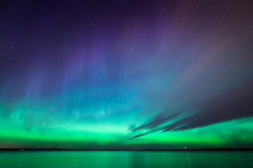 Wall Mural - northern lights over lake in finland