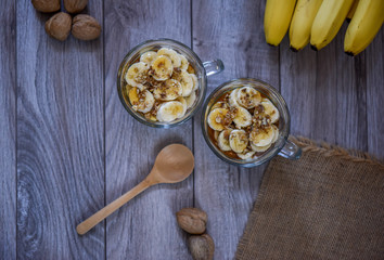 granola with yogurt, bananas and whole walnuts, maple syrup clea