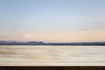 Empty tabletop over outdoor landscape sunset vintage sky backgro