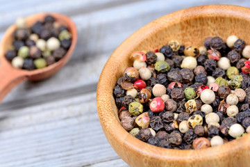 Poster - Colorful peppercorns in a bowl and spoon