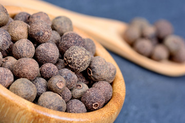 Poster - Bowl with allspice on slate