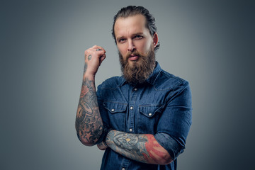 Canvas Print - Bearded man with tattoos on arms.