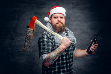 A man in Santa's hat drinking beer.