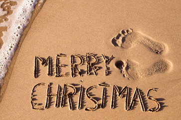 Wall Mural - text merry christmas in the sand of a beach