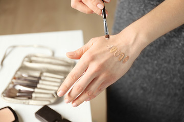 Poster - Female visagiste applying cosmetics onto hand