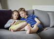 © Mint Images - Siblings sharing digital tablet