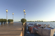 3d Rendering Wood Pier Near Sea With Retro Boat