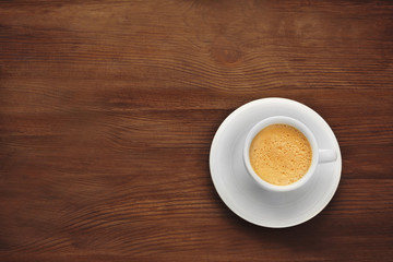 Wall Mural - Cup of coffee on wooden background