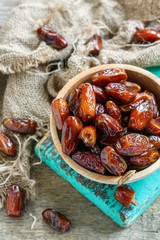 Cup with dried dates and old sacking.