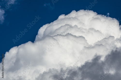 Fotografering Mountainous Cumulus Clouds Boiling in the Bright Blue Summer Sky