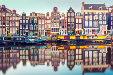 Fototapete - Amsterdam canal Singel with typical dutch houses and houseboats during morning blue hour, Holland, Netherlands. Used toning
