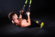 © smartbobert - One young handsome brave curly bearded muscled man with a beard makes Total Resistance eXercises fitness trx straps working out in gym crossfit
