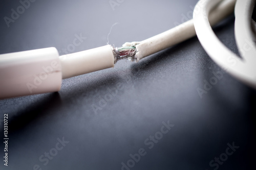 Fotografia, Obraz Closeup the Broken Smart Phone Charger Cable on black Background