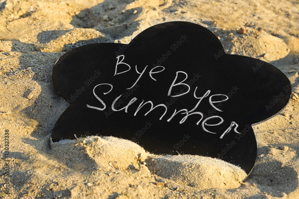 Black board with inscription on sea beach