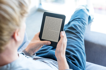 Man reading a book on digital device