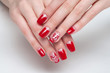 © dina_shuba - Christmas red manicure with painted Christmas toys, heart