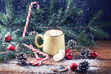 Fototapeta Desenie - mug with hot chocolate, christmas tree, tangerines, peppermint stick and marshmallow on a snow wooden background with falling snow. Dark photo. Empty space for text. Toned for art effect