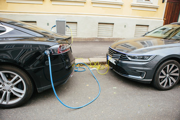 Sticker - Electric car charging. City street.