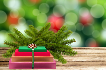 Christmas holiday background with tree branch and gift box on wo