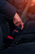Cropped shot of male driver fastening seat belt