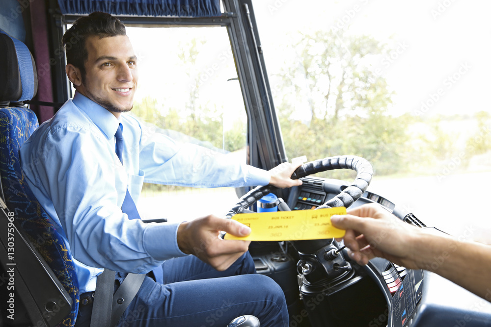 Bus driver taking ticket from passenger