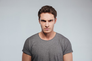 close up of angry irritated young man looking camera