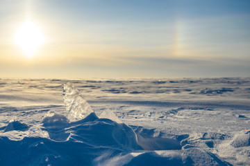 Snowy landscape, ice, wind and blizzard, extreme cold.