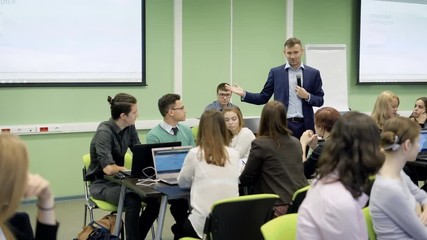 group of students in classroom at the university are listening attentively the lecture on economics 