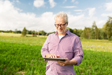 Poster - senior man with tablet pc computer at county