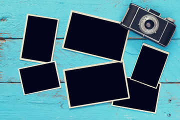 Wall Mural - Top view of empty photo frames next to old camera