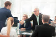 © ASDF - Business partners shaking hands after a successful transaction.