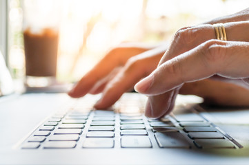 Hands typing on laptop computer