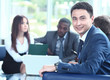 © ASDF - Confident young business man attending a meeting with his colleagues
