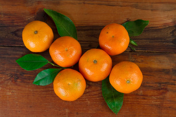 Wall Mural - tangerines organic fruit top view over wooden background