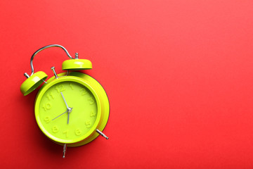 Green alarm clock on a red background