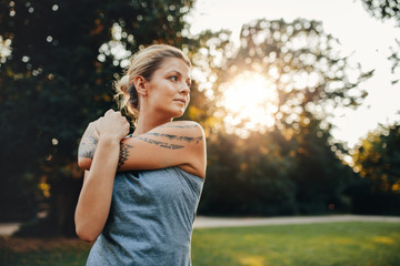 Wall Mural - Female exercising at the park in morning