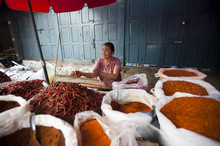 A Woman Selling Spices On A Market Stall In Shan State